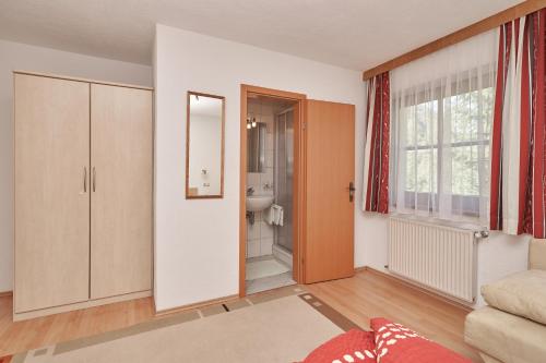 ein Wohnzimmer mit einer Tür zum Bad in der Unterkunft Appart Klotz in Längenfeld