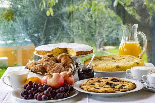 a table topped with different types of bread and fruit at CorteViva Boutique B&B in Perugia