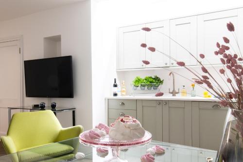 a kitchen with a table with a cake on it at PHENOMENAL OXFORD STREET 5bedroom DESIGN HOUSE NOMADS XXL GROUPS LOVE IT! in London