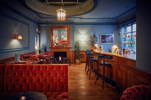 a living room filled with furniture and a fire place at The Green Dragon Hotel in Hereford