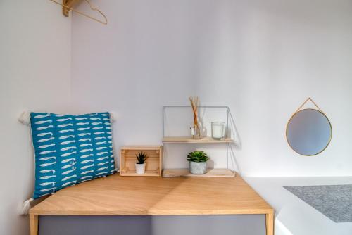 a wooden table with a mirror and plants on it at L Her Beau d Hier in LʼÉpine