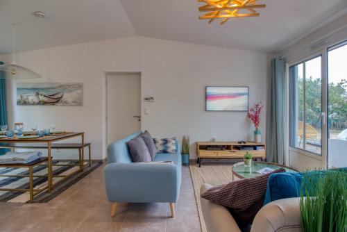 a living room with a couch and a table at L Her Beau d Hier in LʼÉpine