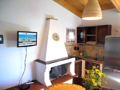 a living room with a tv and a fireplace at Casa Anselmi in Portoferraio