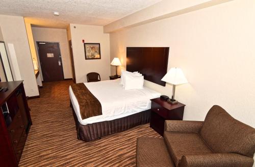 a hotel room with a bed and a couch at Cobblestone Inn & Suites - Clarion in Clarion