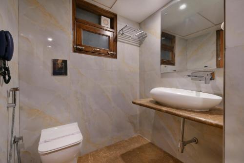 a bathroom with a sink and a toilet at Hotel Blue Pearl in New Delhi