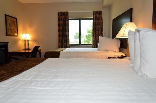 a hotel room with two beds and a window at Cobblestone Inn & Suites - Clarion in Clarion