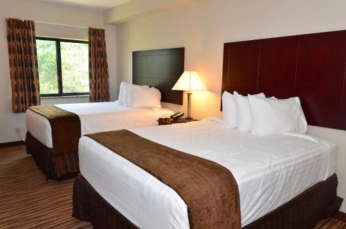 a hotel room with two beds and a window at Cobblestone Inn & Suites - Clarion in Clarion