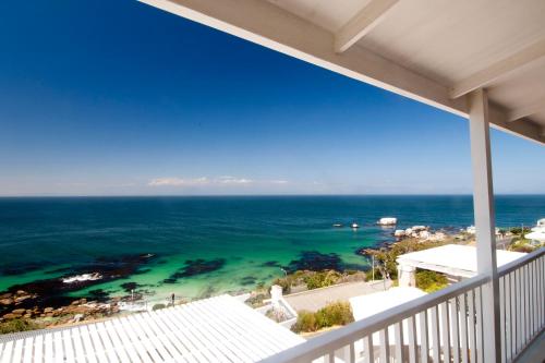 a view of the ocean from the balcony of a house at Felsensicht Holiday Home in Simonʼs Town
