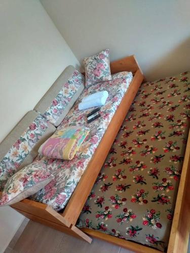 a bed with a wooden frame in a room at Pousada Ilha Sul in Cananéia