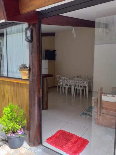 a view of a living room with a table and chairs at Pousada Ilha Sul in Cananéia