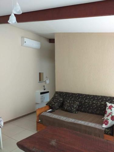 a living room with a couch in a room at Pousada Ilha Sul in Cananéia