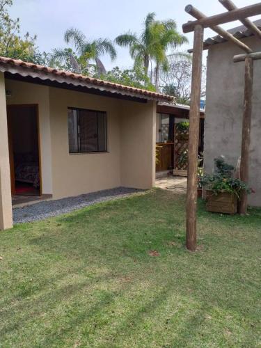a house with a grass yard in front of it at Pousada Ilha Sul in Cananéia