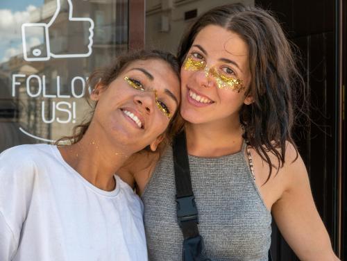 two women with gold glitter on their faces at Lobby Collective Hostel - Lecce in Lecce