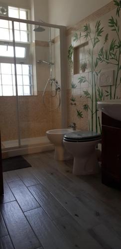 a bathroom with a shower and a toilet and a sink at A casa tua B&B in Rome