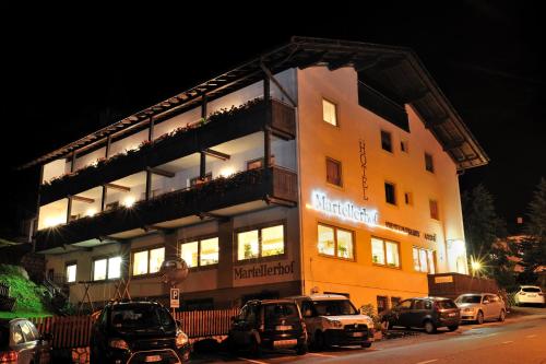 a building with cars parked in front of it at Hotel Martellerhof in Martello