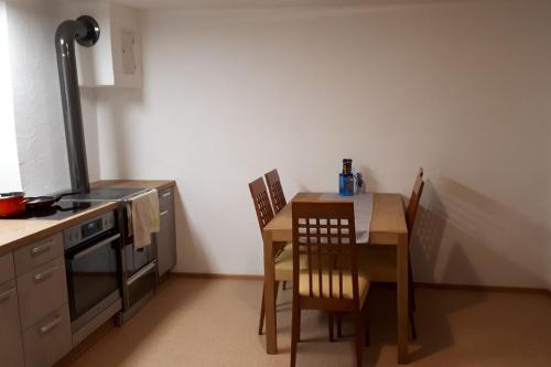 a kitchen with a table and a table and chairs at Ferienhaus Monika in Gutschau