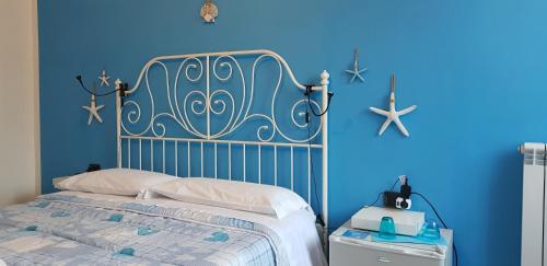 a blue bedroom with a bed and a blue wall at A casa tua B&B in Rome