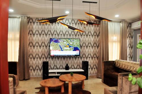 a living room with a couch and a tv at J Gibson Hotel in Lagos