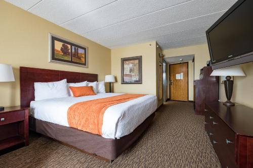 a hotel room with a bed and a flat screen tv at Comfort Inn Eagan Minneapolis - St Paul South in Eagan