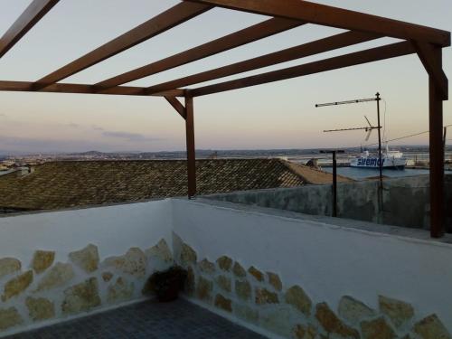 a view from the roof of a house with a boat in the distance at Appartamento L'Ammiraglio in Trapani