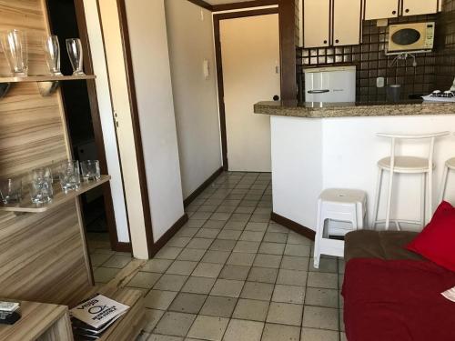 a living room with a kitchen and a counter top at Apartamento Velozo Santos in Salvador