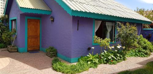 una casa morada y verde con una puerta en Las Tinajas Frente A La Playa en Coquimbo