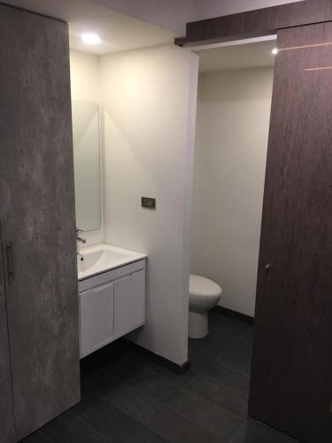 a white bathroom with a toilet and a sink at HOTEL ZARCILLEJO in Pasto