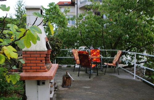 a patio with two chairs and a table on a fence at Apartment Rosa in Rijeka