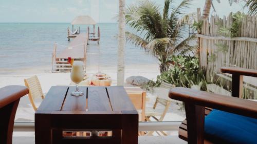 a table with a drink on top of a beach at Cielo Maya Beach Tulum in Tulum