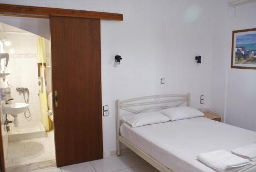 a bedroom with a bed and a bathroom with a shower at Grammatoula in Nikiana