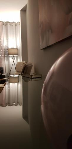 a room with a table and a chair and a lamp at La Parada de Echegaray in Zaragoza