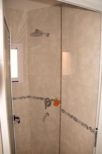 a shower with a glass door in a bathroom at ARROYO SUITE HOUSE in Mina Clavero