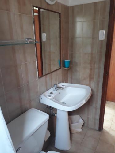 uma casa de banho com um lavatório, um WC e um espelho. em Cabañas y Departamentos Las Golondrinas em Coquimbo