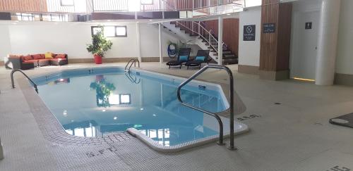 a large swimming pool in a large building at Super 8 by Wyndham Spruce Grove in Spruce Grove