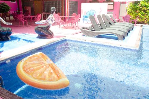 a pool with a slice of orange in the water at Santuario Playa in Playa del Carmen