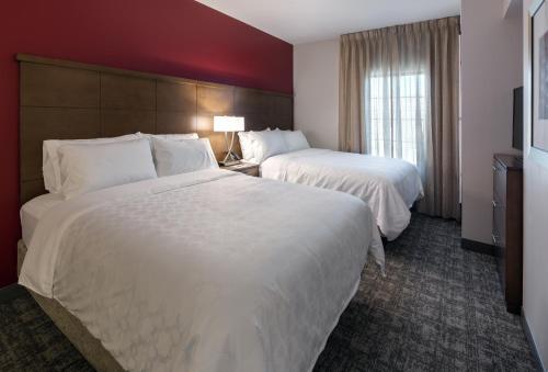 a hotel room with two beds and a window at Staybridge Suites - Phoenix – Biltmore Area by IHG in Phoenix