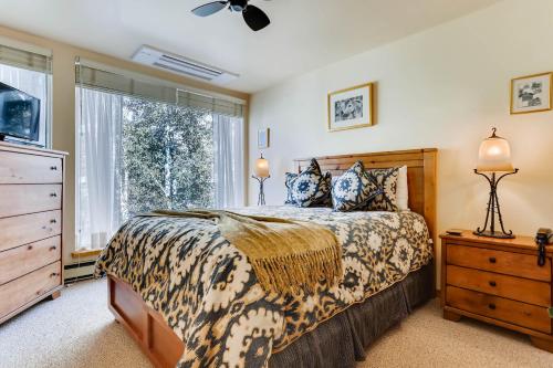 a bedroom with a bed and a dresser and a window at Simba Run Vail Condominiums in Vail