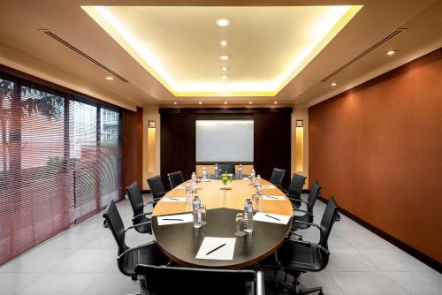 a conference room with a large table and chairs at Patong Paragon Resort & Spa SHA Extra Plus in Patong Beach