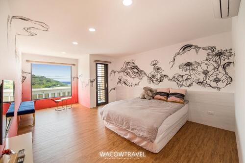 a bedroom with a bed with a teddy bear on it at Twenty Eight B&B in Xiaoliuqiu