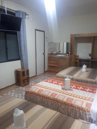 a large room with two beds and a bathroom at Casa Nativa Iquitos in Iquitos