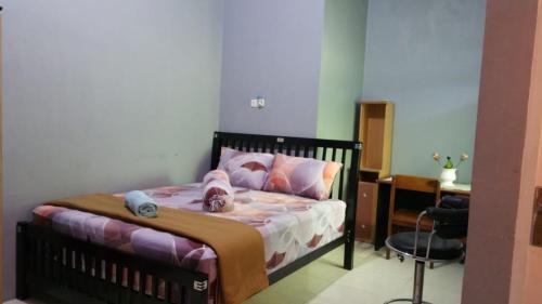 Ένα ή περισσότερα κρεβάτια σε δωμάτιο στο The Carstensz Homestay