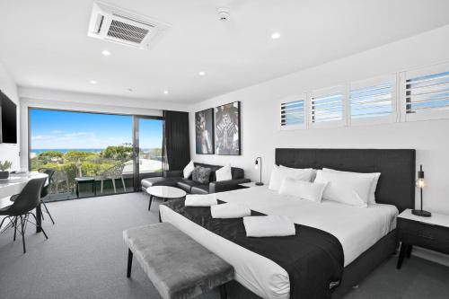 a bedroom with a large bed and a living room at Ocean Grove Chalet in Ocean Grove