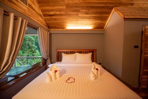 a bedroom with a bed with towels on it at Luxury Camp@Green Jungle Park in Luang Prabang