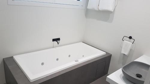 a white bathroom with a sink and a toilet at Ocean Grove Chalet in Ocean Grove
