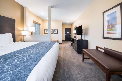 a hotel room with a bed and a couch and a tv at Comfort Suites Marysville Columbus - Northwest in Marysville