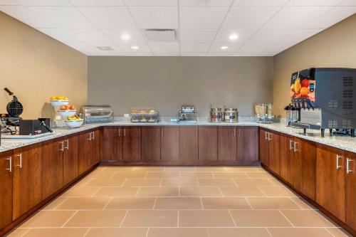 a large kitchen with wooden cabinets and counter tops at Comfort Inn & Suites Florence Center Area in Florence