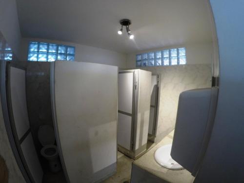 a bathroom with a toilet and a mirror at Sky Club Eco Hotel in Belén de Umbría