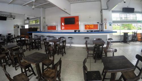an empty restaurant with tables and chairs and a bar at Sky Club Eco Hotel in Belén de Umbría