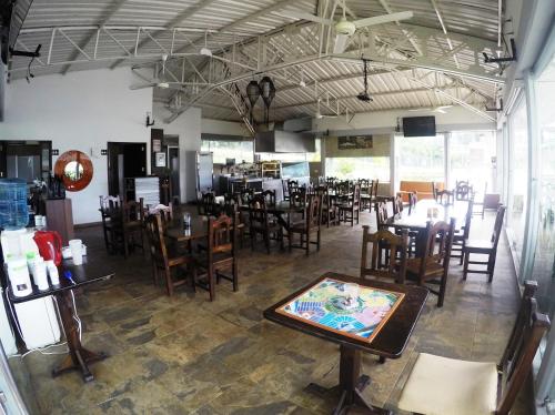 a dining room with tables and chairs in a restaurant at Sky Club Eco Hotel in Belén de Umbría