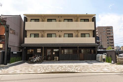 a building on a street in front of a building at Tabist Kyogura Kyoto Nijo in Kyoto